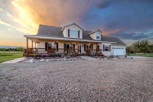 View of front of house with covered porch and a garage