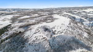 Snowy aerial view featuring a mountain view