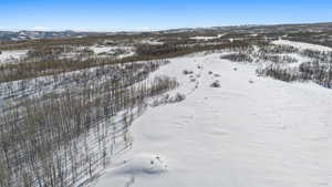 Snowy aerial view featuring a mountain view