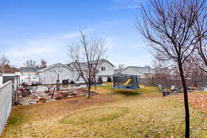 View of yard featuring a patio and a trampoline