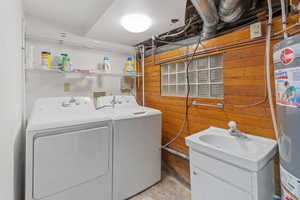 Washroom featuring separate washer and dryer and sink