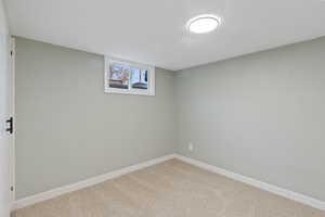 Basement with light colored carpet