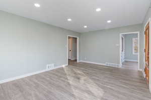 Spare room featuring light wood-type flooring