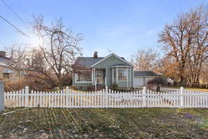 View of front of house with a garage and a front lawn