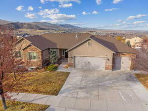 Ranch-style home featuring a mountain view and a garage