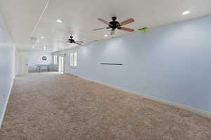 Interior space featuring ceiling fan and carpet