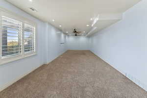 Spare room featuring ceiling fan and carpet floors