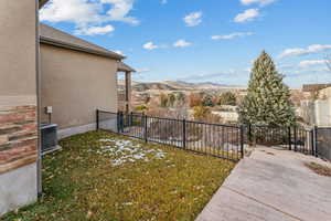 View of yard with a mountain view and central AC