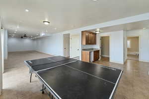 Playroom with light tile patterned floors and ceiling fan