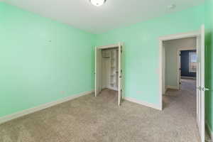 Unfurnished bedroom featuring light colored carpet