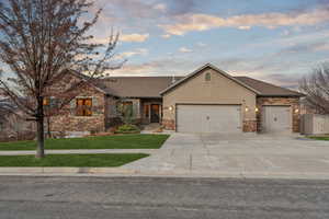 View of front of home featuring a yard and a garage