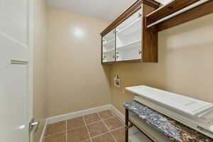 Laundry area featuring washer hookup and cabinets