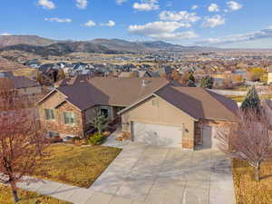 Ranch-style house featuring central AC, a mountain view, and a garage