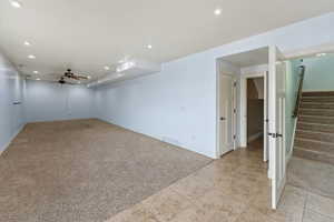 Carpeted empty room with ceiling fan