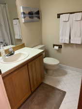 Bathroom featuring tile patterned floors, vanity, and toilet