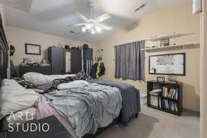 Carpeted bedroom with ceiling fan and lofted ceiling