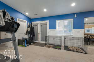 Interior space featuring carpet and vaulted ceiling