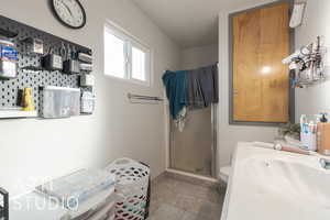 Bathroom featuring toilet and a shower with door