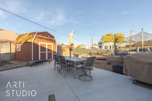 View of patio / terrace with a grill, a storage unit, and a trampoline