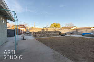 View of yard featuring a storage unit and a patio area