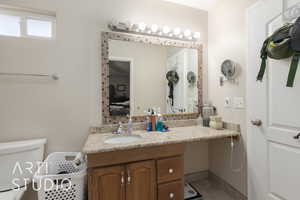 Bathroom featuring tile patterned floors, vanity, and toilet