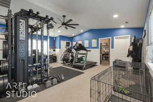 Gym with carpet flooring, ceiling fan, and vaulted ceiling