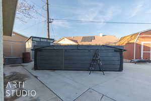 View of patio with a shed