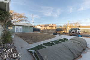 View of yard featuring french doors and a trampoline