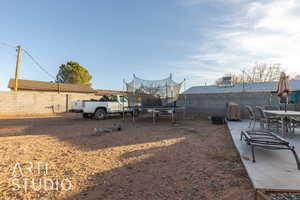 View of yard with a patio area and a trampoline