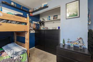 Bedroom featuring carpet and a textured ceiling