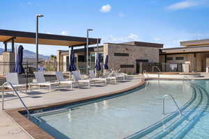 View of swimming pool with a mountain view and a patio area