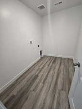 Laundry area with washer hookup, dark hardwood / wood-style floors, and hookup for an electric dryer