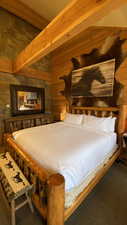 Carpeted bedroom with wood walls