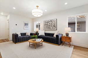 Living room with a wealth of natural light and light hardwood / wood-style flooring