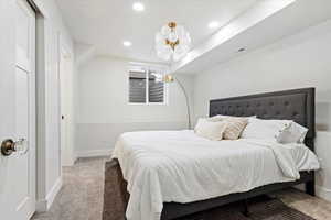 Bedroom featuring light colored carpet