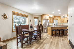 Dining area featuring sink and light hardwood / wood-style floors