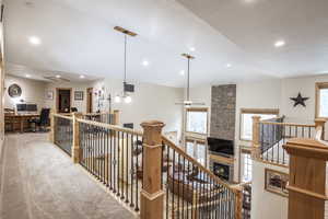 Hallway featuring a wealth of natural light and carpet floors