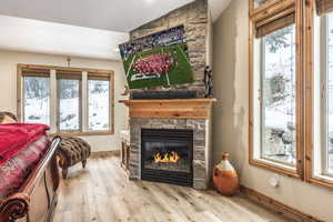 Living area with light hardwood / wood-style floors and a fireplace