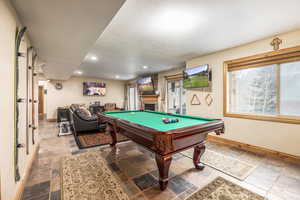 Rec room featuring a fireplace and pool table