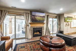 Living room with a fireplace and a healthy amount of sunlight