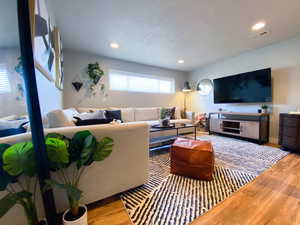 Downstairs Living room with wood-type flooring