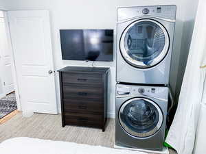 Clothes washing area featuring stacked washer / drying machine Within the Upstairs Queen Bedroom