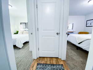 Upstairs hallway to Bedrooms with hardwood / wood-style flooring