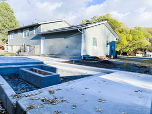 Back of house featuring an outdoor fire pit