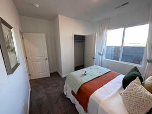 Carpeted bedroom with a closet