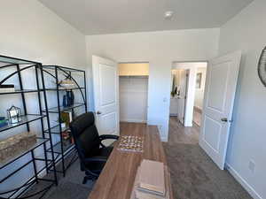 Office featuring dark colored carpet