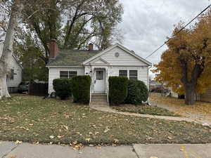 Bungalow-style house with a front yard