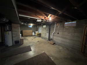 Basement with washer and clothes dryer and gas water heater