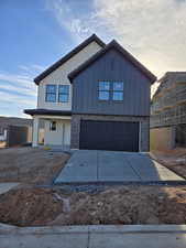 View of front facade featuring a garage