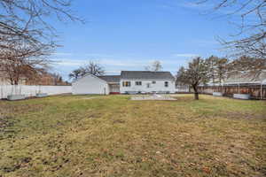 Back of property with a yard and a patio